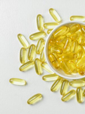 Photo by Aknarin Thika High-angle shot of omega-3 fish oil capsules in a ceramic bowl on a white background.
